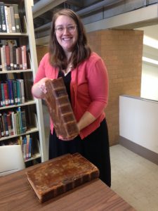 Librarian Elizabeth Hartig with the "new" Bible for the rare books room.