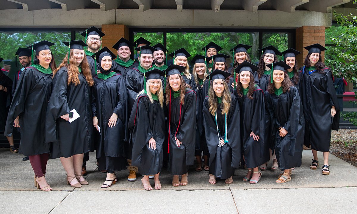 Photo of a large group of graduating CUAA students, wearing caps and gowns.