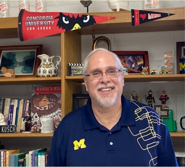 David Kusch shows his Cardinal pride as a Lutheran high school English teacher.