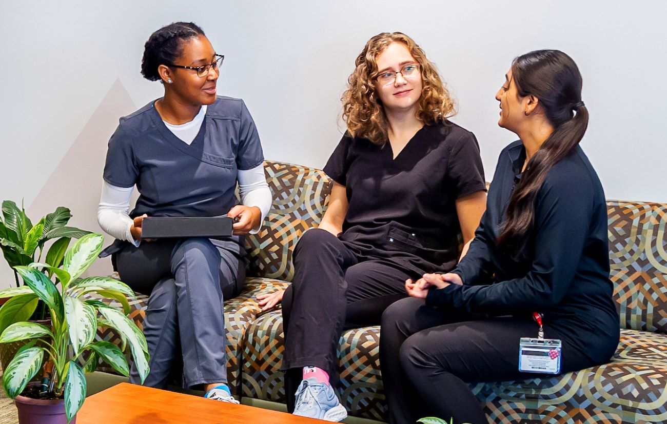 three students talking
