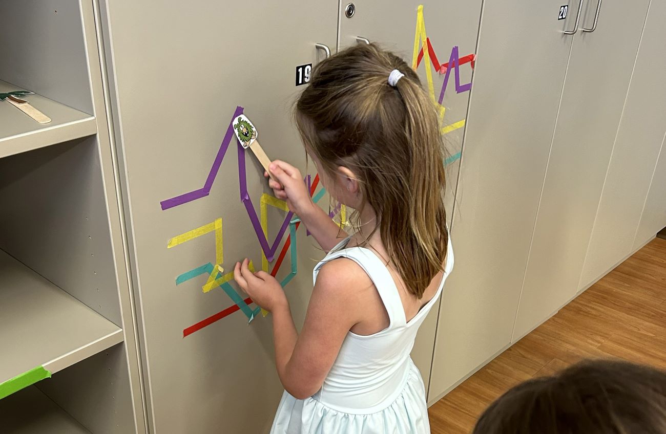 kid following bright lines on wall