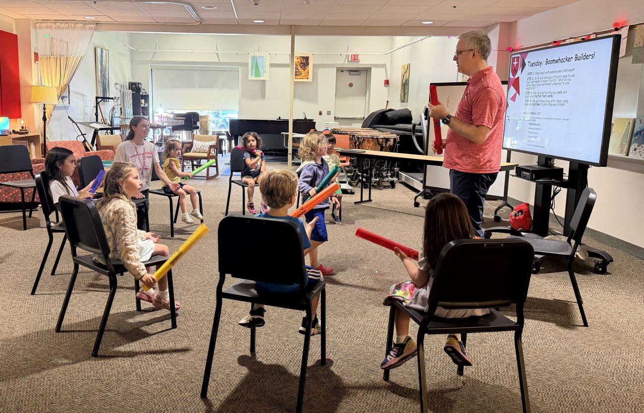 kids in classroom with colored foam sticks