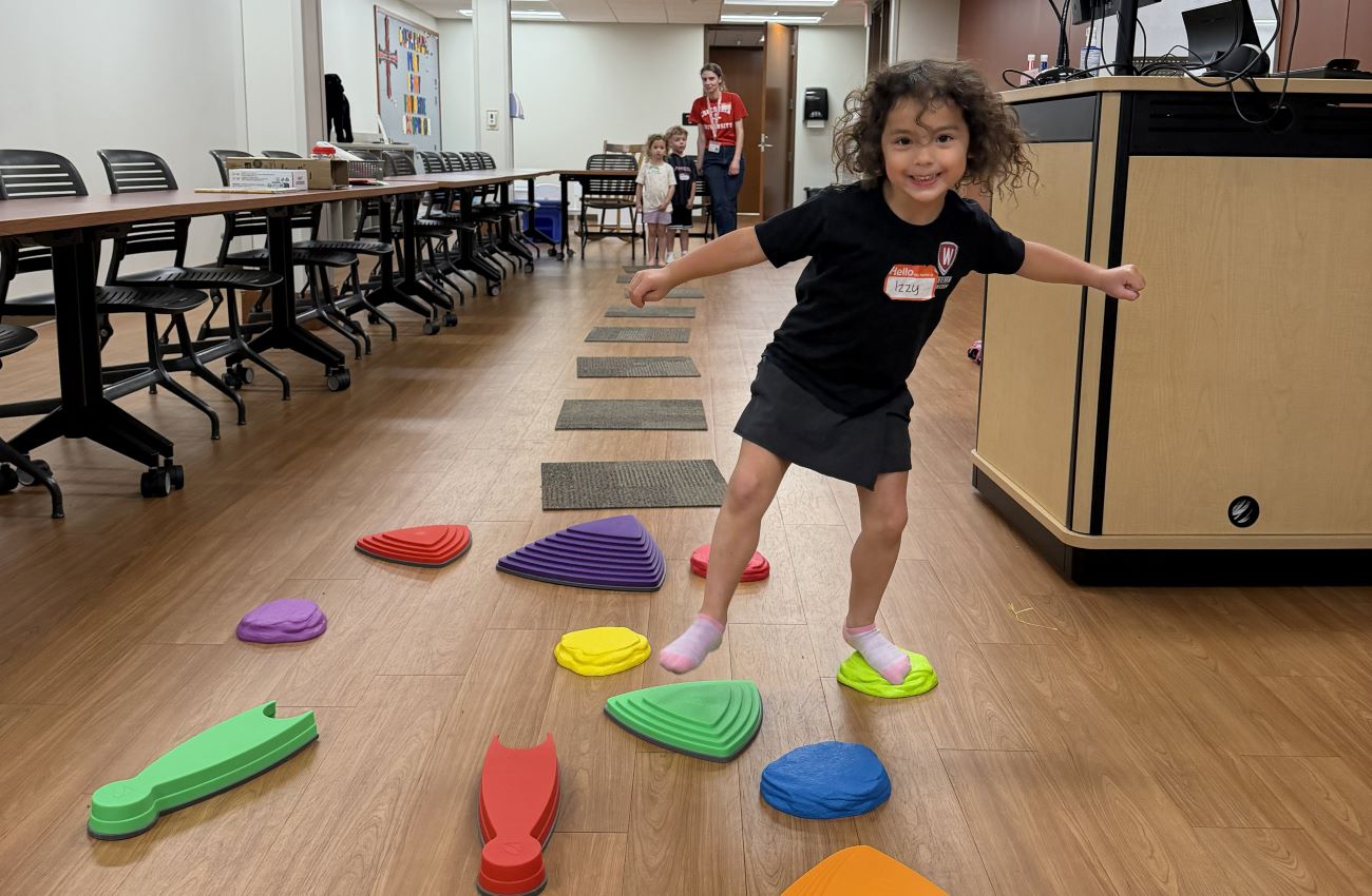 kid following colored shapes on floor