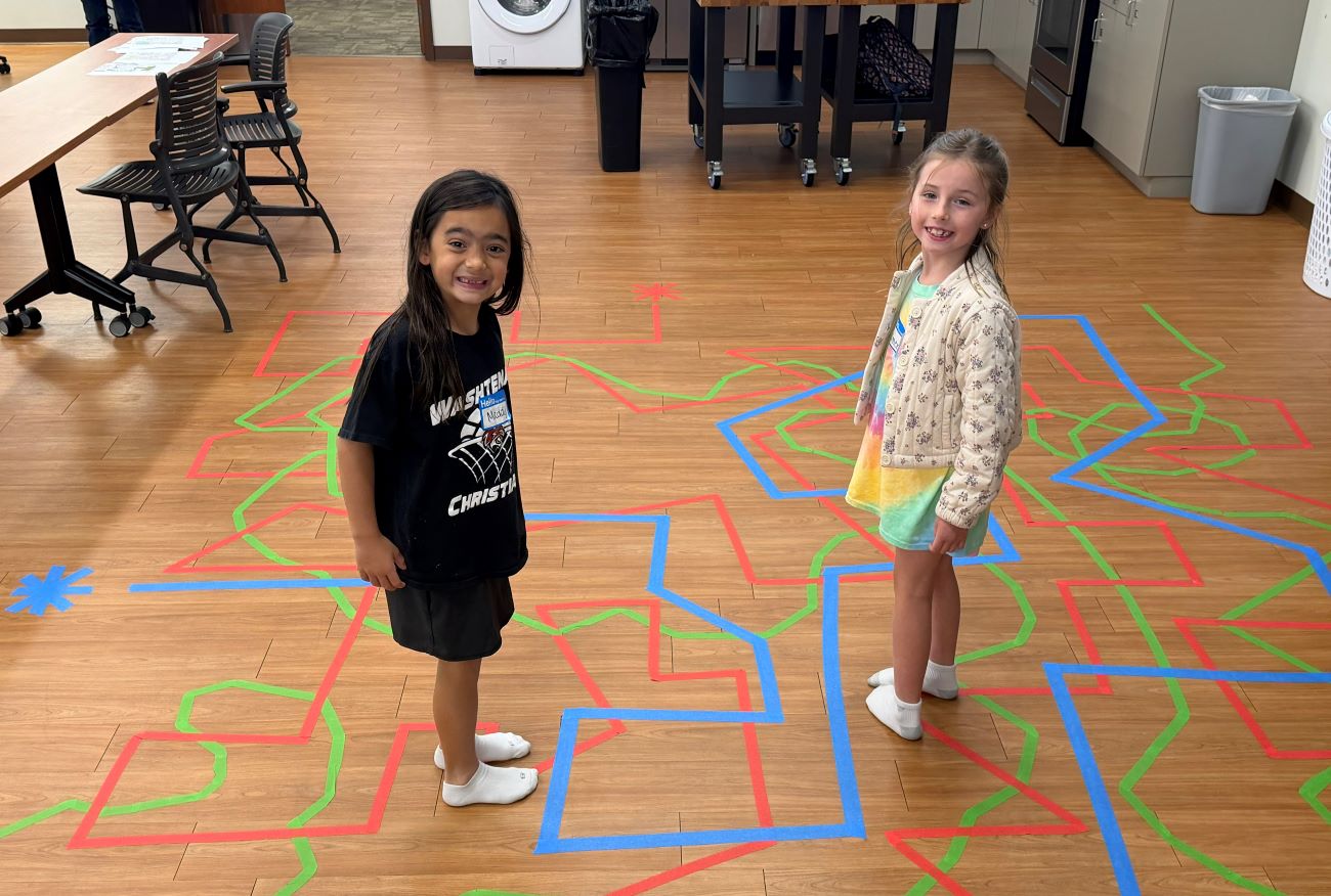 kids standing on floor with bright colored lines