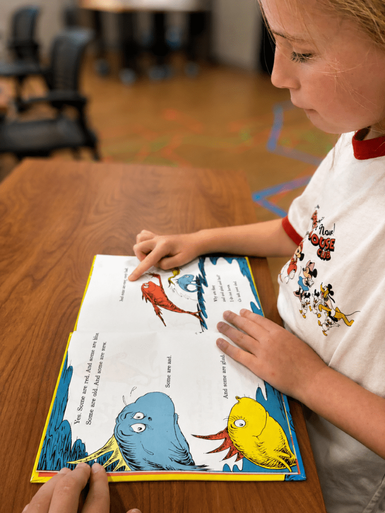 young child reading book