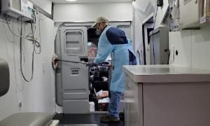 Stinson ('19) cleans out the medical van after caring for patients.